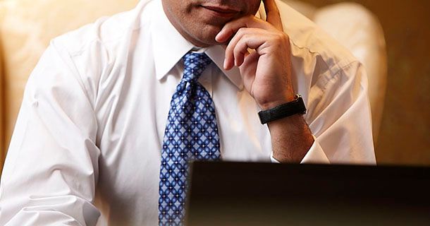 Business man sitting in front of a laptop computer