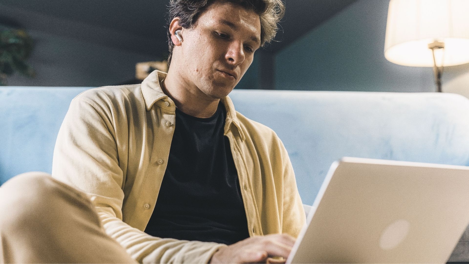 Person sitting in front of a laptop at home.