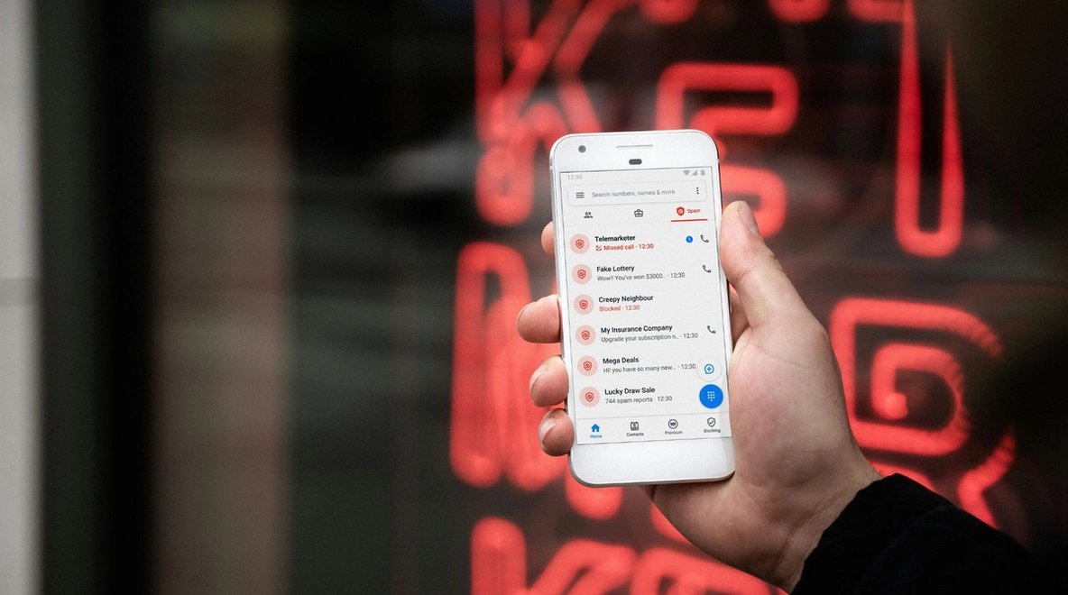 Close-up of a smartphone screen showing a list of blocked and flagged calls.