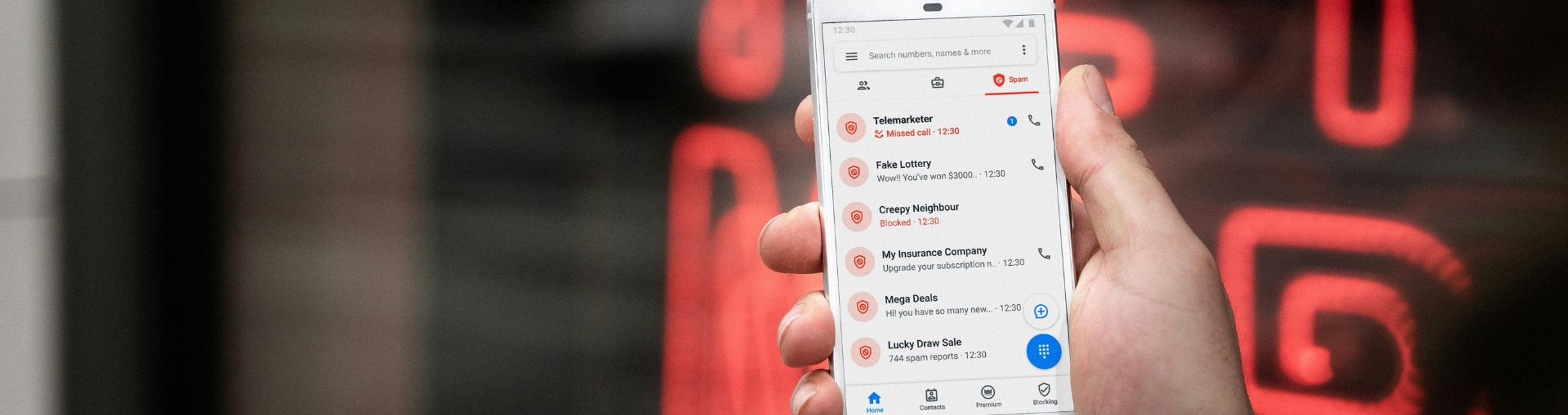 Close-up of a smartphone screen showing a list of blocked and flagged calls.